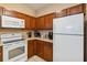 Cozy kitchen space with modern appliances, wood cabinetry, and tile flooring at 3175 Feltrim Pl # 101, Kissimmee, FL 34747