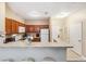 The kitchen features wood cabinetry and white appliances, with barstool seating at the counter at 3175 Feltrim Pl # 101, Kissimmee, FL 34747