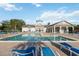 Community pool with clear water and comfortable lounge chairs at 3175 Feltrim Pl # 101, Kissimmee, FL 34747