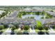 Townhouse community situated near a pond, with lush landscaping and a picturesque view of the neighborhood at 3181 Tocoa Cir, Kissimmee, FL 34746
