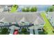 An elevated view of townhouses near a pond, showcasing the roofs, garages, and surrounding greenery at 3181 Tocoa Cir, Kissimmee, FL 34746