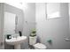 Bathroom features a white toilet and sink, with a plant and grey walls at 3181 Tocoa Cir, Kissimmee, FL 34746