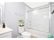 A full bathroom features a shower-tub combo, a plant, and white tiled walls at 3181 Tocoa Cir, Kissimmee, FL 34746