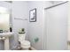 Functional bathroom with modern fixtures, pedestal sink, and a shower with glass door at 3181 Tocoa Cir, Kissimmee, FL 34746