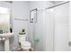 Functional bathroom with modern fixtures, pedestal sink, and a shower with frosted door at 3181 Tocoa Cir, Kissimmee, FL 34746