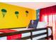 A comfy bunk bed is decorated with red blankets in this colorfully decorated bedroom at 3181 Tocoa Cir, Kissimmee, FL 34746