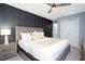 Charming bedroom with king bed, ceiling fan, walk in closet, and a view of the en suite bathroom at 3181 Tocoa Cir, Kissimmee, FL 34746