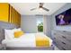 Well-lit bedroom with gray walls, a wooden slat accent, and a large flat-screen TV at 3181 Tocoa Cir, Kissimmee, FL 34746