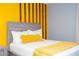 Bedroom features a gray bed frame with a yellow accent pillow and blanket at 3181 Tocoa Cir, Kissimmee, FL 34746