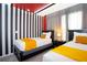Bright bedroom featuring two twin beds with striped walls and lively orange accents at 3181 Tocoa Cir, Kissimmee, FL 34746