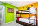 A bunk bed is placed in this bedroom decorated with lime green and yellow walls at 3181 Tocoa Cir, Kissimmee, FL 34746