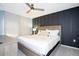 Comfortable bedroom features a ceiling fan, paneled accent wall, and matching dresser at 3181 Tocoa Cir, Kissimmee, FL 34746