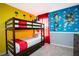 Bright bedroom with a wooden bunk bed, carpet, and a 'Toy Story' themed mural at 3181 Tocoa Cir, Kissimmee, FL 34746