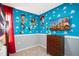 Fun 'Toy Story' themed bedroom featuring neutral carpet and wooden dresser at 3181 Tocoa Cir, Kissimmee, FL 34746