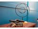 Home decor features an artistic metal ring display and a book arrangement with the words 