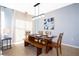 Bright dining area features modern lighting fixture and unique wood table and bench seating at 3181 Tocoa Cir, Kissimmee, FL 34746