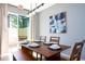 Elegant dining room with a wooden table, seating for six, and modern artwork on the wall at 3181 Tocoa Cir, Kissimmee, FL 34746