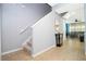Bright entryway featuring neutral walls, tile flooring, and a staircase with white railing at 3181 Tocoa Cir, Kissimmee, FL 34746