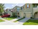 Inviting townhouse exterior with a two-car garage and well-maintained landscaping and beautiful shutters at 3181 Tocoa Cir, Kissimmee, FL 34746