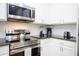 Modern kitchen features stainless steel appliances, granite countertops, and white cabinets at 3181 Tocoa Cir, Kissimmee, FL 34746