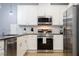 Updated kitchen featuring stainless steel appliances, white cabinets, and ample counter space at 3181 Tocoa Cir, Kissimmee, FL 34746