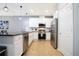 Modern kitchen boasts stainless steel appliances, sleek white cabinetry, and pendant lighting at 3181 Tocoa Cir, Kissimmee, FL 34746