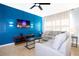 Comfortable living room features bright blue accent wall, modern furniture, and ceiling fan at 3181 Tocoa Cir, Kissimmee, FL 34746
