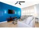 Comfortable living room features bright blue accent wall, modern furniture, and ceiling fan at 3181 Tocoa Cir, Kissimmee, FL 34746