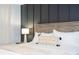 A closer view of the main bedroom, features a decorative lamp, pillows and blanket on a king bed at 3181 Tocoa Cir, Kissimmee, FL 34746