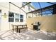 Outdoor patio features a grill and outdoor dining table and chairs within a screened in enclosure at 3181 Tocoa Cir, Kissimmee, FL 34746