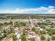 Aerial view of a charming residential neighborhood featuring tree-lined streets and cozy homes near a lake at 320 S Seminole Ave, Lake Alfred, FL 33850