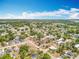 High-angle view of a residential area, showcasing houses and streets spread across a lush green landscape at 320 S Seminole Ave, Lake Alfred, FL 33850