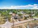 An aerial view showcasing houses in the neighborhood with a mix of mature trees and green space at 320 S Seminole Ave, Lake Alfred, FL 33850