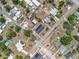 Aerial view of a neighborhood featuring solar panel rooftops, pools, neatly arranged streets, and lush greenery at 320 S Seminole Ave, Lake Alfred, FL 33850