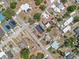 Aerial view showing neighborhood rooftops with solar panels, trees, pools, offering modern, sustainable living at 320 S Seminole Ave, Lake Alfred, FL 33850