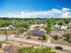 An aerial view of the surrounding neighborhood, showcasing lush trees and residences at 320 S Seminole Ave, Lake Alfred, FL 33850
