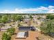 Aerial neighborhood shot showcasing solar panels, mature trees, and neatly arranged streets, offering modern sustainable living at 320 S Seminole Ave, Lake Alfred, FL 33850