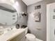 Charming bathroom featuring a framed mirror, updated fixtures, and a convenient walk-in shower at 320 S Seminole Ave, Lake Alfred, FL 33850
