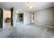 Carpeted bedroom features an open doorway, mirrored closet doors, and modern ceiling fan at 320 S Seminole Ave, Lake Alfred, FL 33850