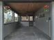 The carport boasts a wooden plank ceiling and floral decorations at 320 S Seminole Ave, Lake Alfred, FL 33850