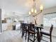 Bright dining area featuring a stylish chandelier and an open flow to the kitchen at 320 S Seminole Ave, Lake Alfred, FL 33850
