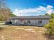 Exterior of a house featuring a tidy front yard, walkway, and a welcoming red front door at 320 S Seminole Ave, Lake Alfred, FL 33850