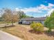 Charming house with a well-kept front yard, walkway leading to the front door, and mature trees at 320 S Seminole Ave, Lake Alfred, FL 33850