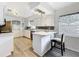A bright kitchen is well-equipped with a breakfast bar and stainless steel appliances at 320 S Seminole Ave, Lake Alfred, FL 33850