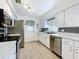 Stylish kitchen featuring stainless steel appliances and updated countertops at 320 S Seminole Ave, Lake Alfred, FL 33850