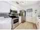 Updated kitchen with stainless steel appliances, subway tile backsplash, and white cabinetry at 320 S Seminole Ave, Lake Alfred, FL 33850