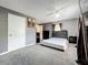 Spacious main bedroom with a sleek, comfortable bed and soft carpet at 320 S Seminole Ave, Lake Alfred, FL 33850