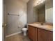 Cozy bathroom featuring wood vanity, toilet, and warm accents at 340 Cimarron Ct, Poinciana, FL 34759