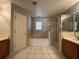 Bathroom featuring a soaking tub, separate shower and vanity with tile flooring and good light at 340 Cimarron Ct, Poinciana, FL 34759