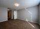 Spacious carpeted bedroom featuring a walk in closet, neutral paint and access to the hallway at 340 Cimarron Ct, Poinciana, FL 34759